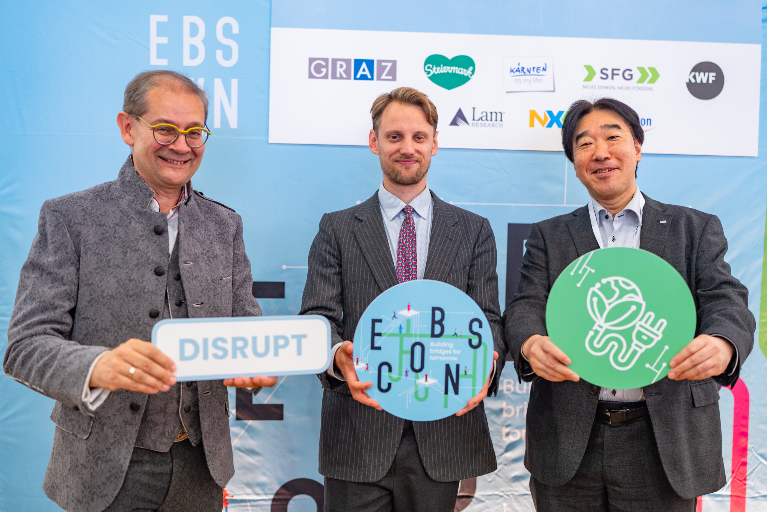 ebscon picture with three people infront of a wall with icons in hand